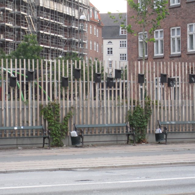 Bird houses lining a fence on Amagerbrogade